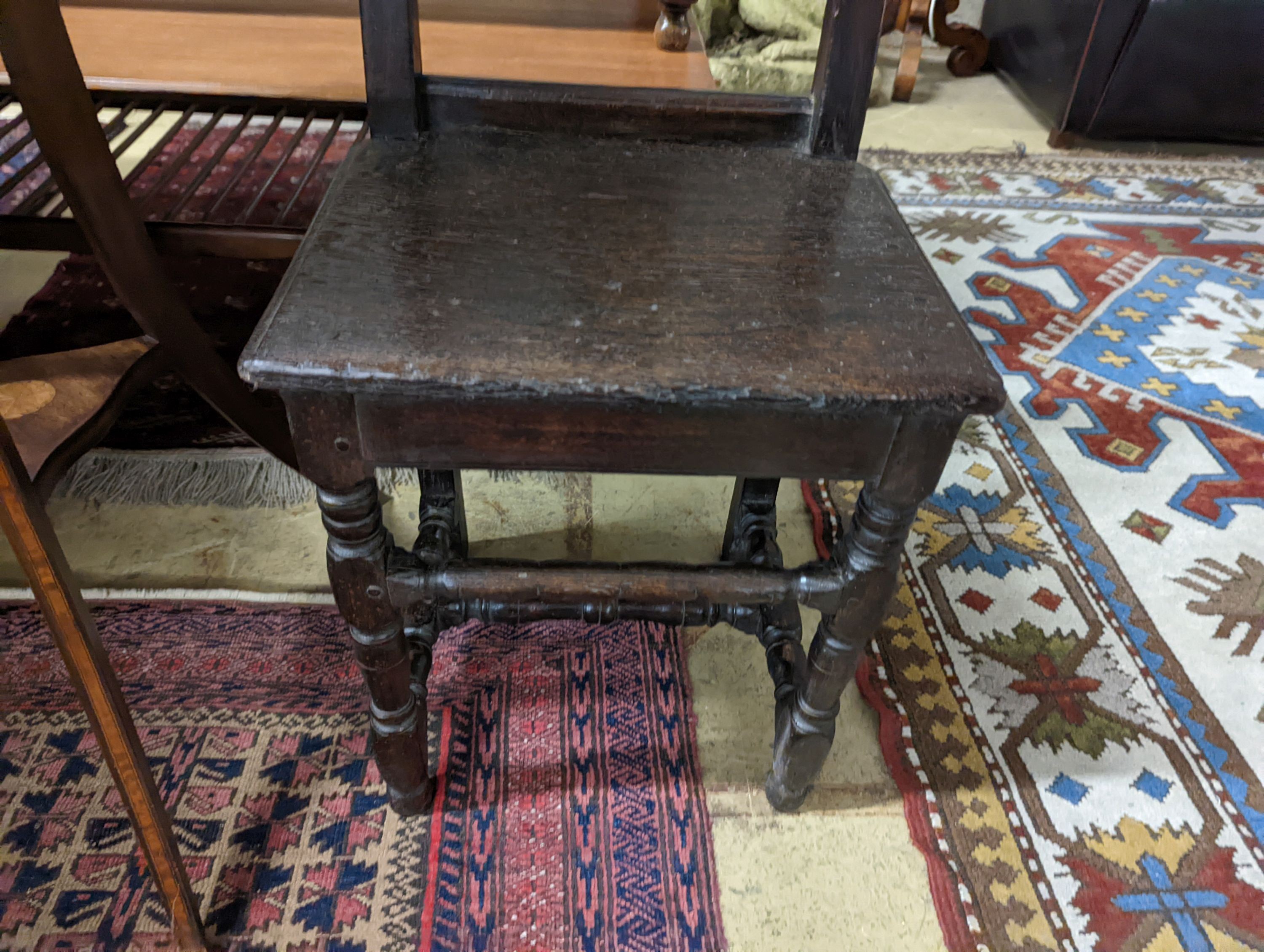 A 17th century style Continental oak back stool, width 40cm, depth 34cm, height 102cm
